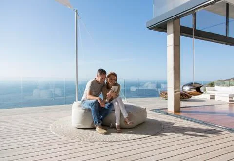 Couple using digital tablet on modern balcony Stock Photos