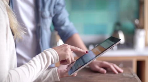 Couple using digital tablet together at home Stock Footage 63283956
