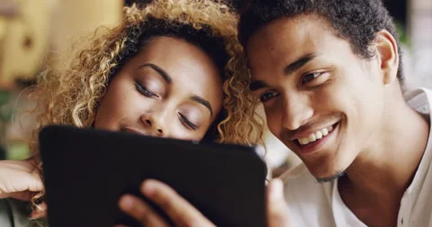 Couple using digital tablet touchscreen ipad watching movies Stock Footage