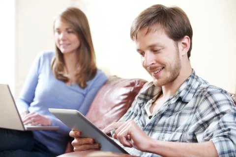 Couple Using Digital Technology At Home Foto stock