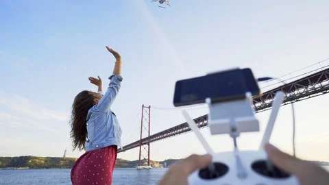Couple using drone on seafront Stock Footage 105193321