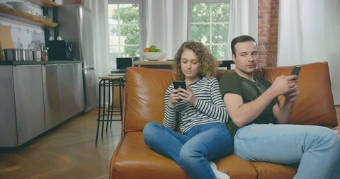Couple using electronic devices on sofa Stock-Footage 114121189