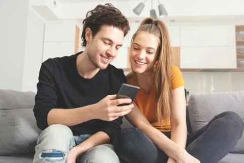 Couple using fast home internet with smart phone 스톡 사진