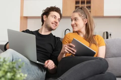 Couple using home internet with mobile devices Fotos de archivo