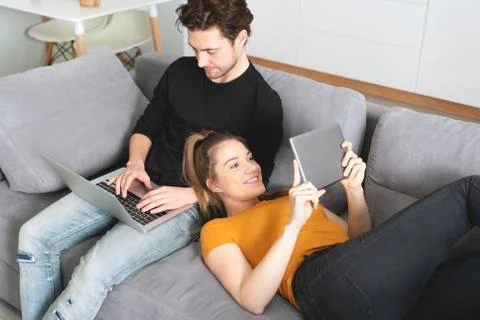 Couple using home internet with mobile devices 스톡 사진