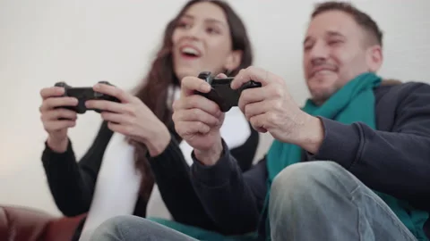 Couple is using a joystick in the room to relax in house. Stock Footage 148161035