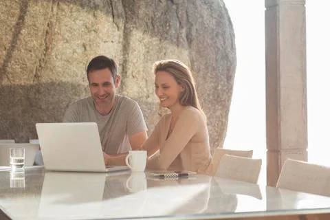 Couple using laptop at breakfast Stock Photos