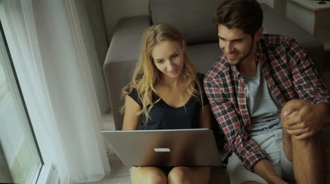 Couple using laptop at home Stock Footage 68801284