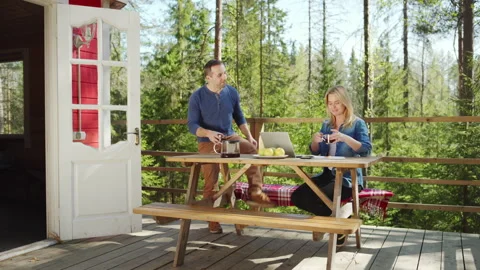 Couple using laptop to plan family budget and home finances in countryside Stock Footage 195359939