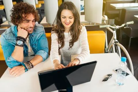 Couple using the laptop in the restaurant. Stock Photos