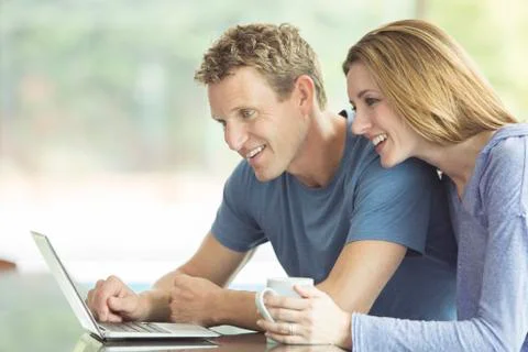 Couple using laptop together Stock Photos
