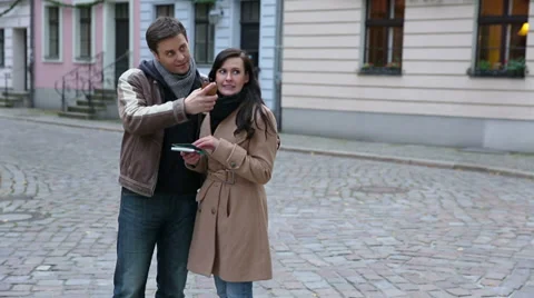 Couple using map and smartphone in city Stock Footage 33402677