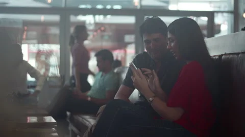 Couple using mobile at cafe. Stock Footage 64095574