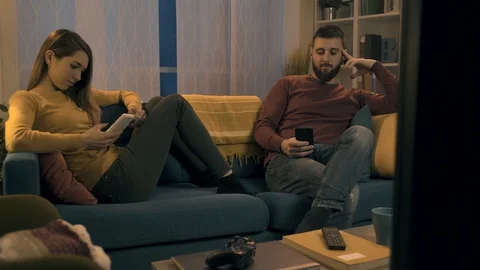 Couple using mobile devices and ignoring each other Stock Footage 128727788