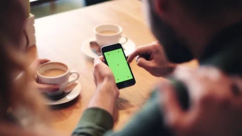 Couple using mobile phone at cafe   스톡 동영상 77706979