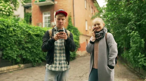 Couple using modern technology in the old alley Stock Footage 51800998