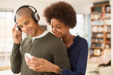 Couple using mp3 player together Stock Photos