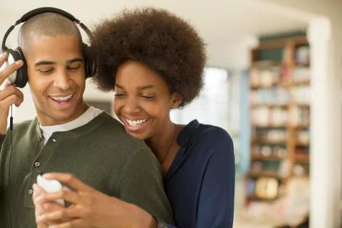 Couple using mp3 player together Stock Photos