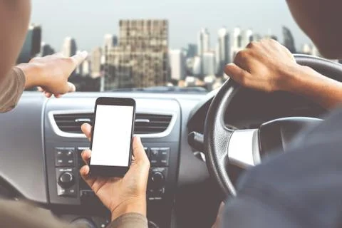 Couple using phone inside car in city direction mobile app concept Stock Photos