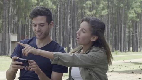 Couple using smart phone to navigate in woods Stock Footage 75199183
