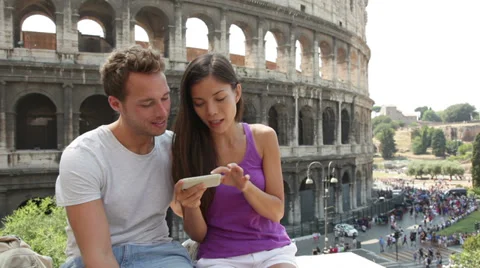 Couple using smart phone in Rome by Colosseum Stock Footage 37260414