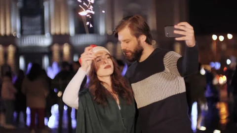 Couple using smart phone talking to family congratulates Merry Christmas. Stock Footage 142234110