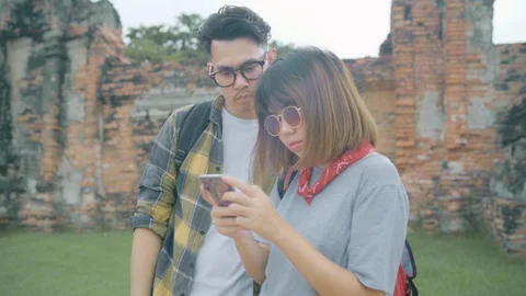 Couple using smartphone for direction location map at Ayutthaya, Thailand Stock Footage 101889619