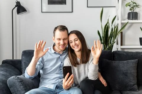 A couple is using smartphone at home Foto stock