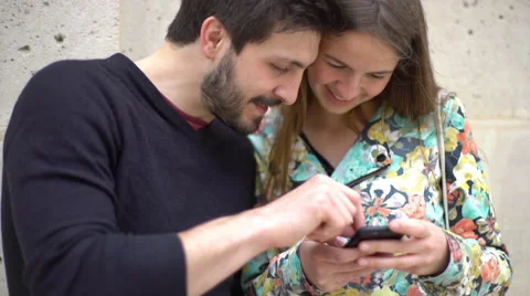 Couple using smartphone together Stock Footage 63302940