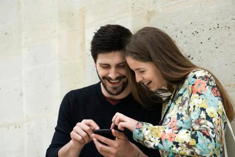 Couple using smartphone together Stock Photos