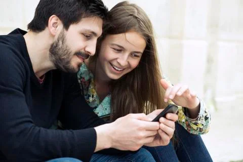 Couple using smartphone together Stock Photos