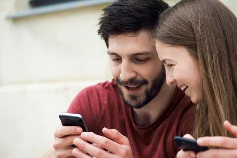 Couple using smartphone together Stock Photos