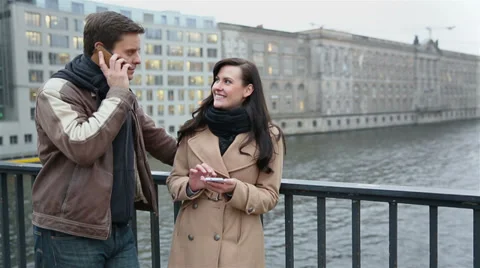Couple using smartphones in city Stock Footage 33403038