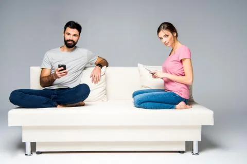 Couple using smartphones Stock Photos