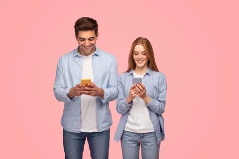 Couple using smartphones in studio Stock Photos