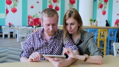 Couple using tablet computer in cafe Stock-Footage 74448218