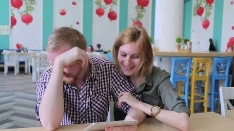Couple using tablet computer in cafe 스톡 동영상 74459468
