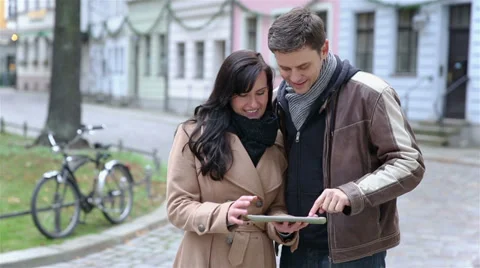Couple using tablet computer in city Stock Footage 33402649