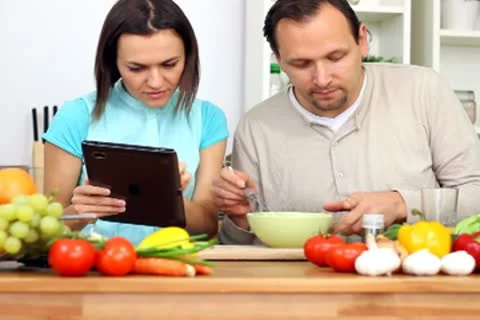 Couple using a tablet computer during cooking Stock Footage 8983440