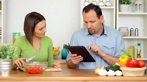 Couple using a tablet computer during cooking Stock Footage 8983461