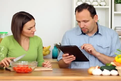 Couple using a tablet computer during cooking Stock Footage 8983470