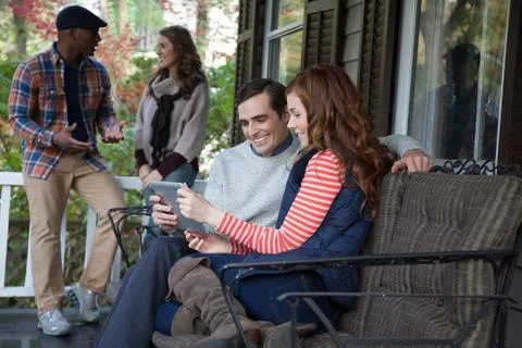 Couple using tablet computer on porch Fotos Stock