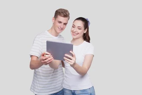 Couple Using Tablet Isolated. Couple Shopping Online. Stock Photos