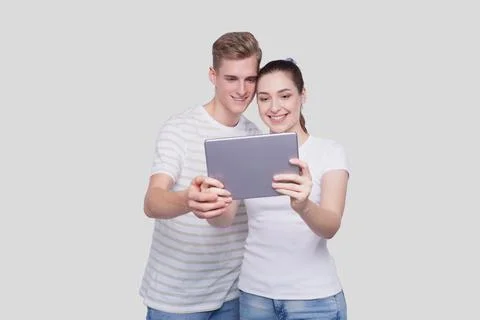 Couple Using Tablet Isolated. Couple Shopping Online. Stock Photos