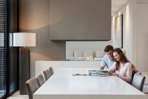 Couple using tablet pc in dining room Stock Photos