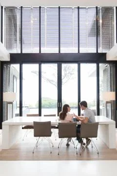 Couple using tablet pc in dining room Stock Photos