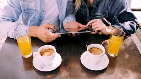 Couple using tablet while sitting at cafe Stock Footage 89866230