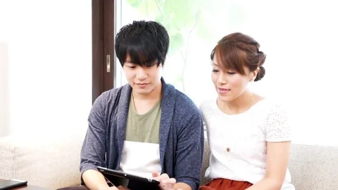 Couple using a tablet（pad） terminal Stock Footage 72559328