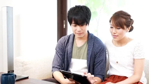 Couple using a tablet（pad） terminal Stock Footage 72559352