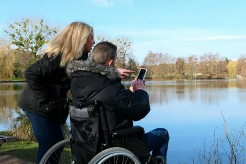 Couple using technology while looking at a smartphone. Foto stock